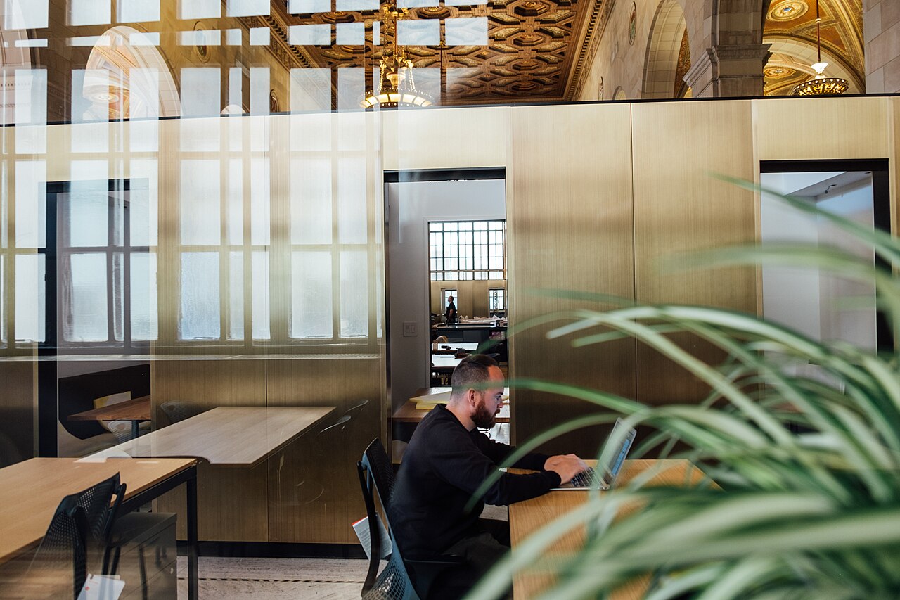 A person working on a laptop in a quiet open office